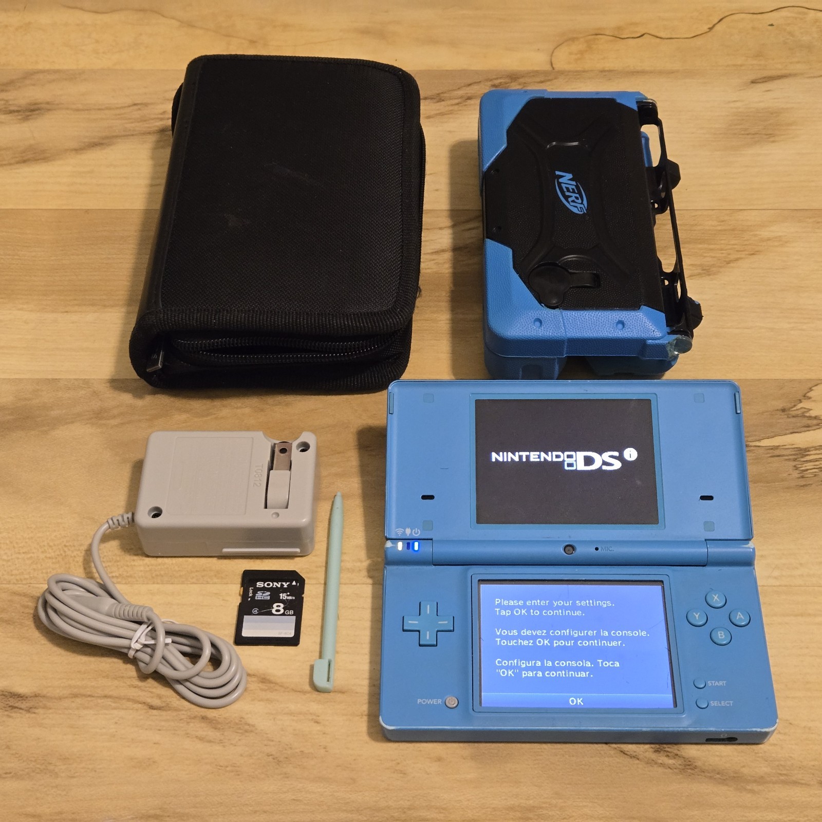 Nintendo DSi Light Blue System w/ Charger, Stylus, Case, Nerf Cover & SD Card